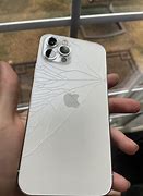 Image result for iPhone 13 Pro Max Broken in Hand On Wood Table