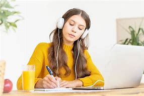 Image result for Image of Woman Studying with Headphones On