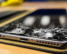 Image result for iPhone 13 Pro Max Broken in Hand On Wood Table