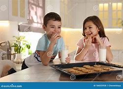 Image result for kid eating cookies and milk