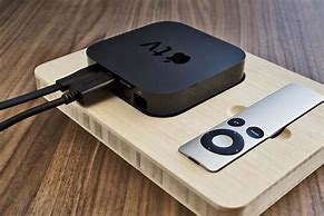 Image result for Apple TV and Remote On Wooden Table