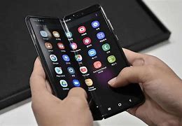 Image result for Man with Folding Cell Phone