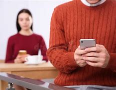 Image result for Ignoring Conversation by Looking at Phone