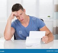 Image result for Stressed Man Looking at Paper