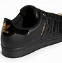 Image result for Finish Line Gold and Black Star Shoes