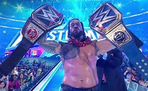 Image result for Roman Reigns Holding Titles