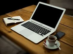Image result for iPhone and Laptop On Table