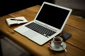 Image result for Apple Laptop in Table