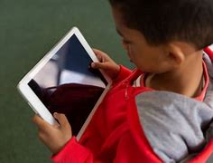 Image result for Boy Holding iPad