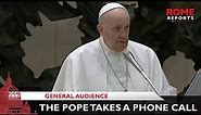 Pope Francis takes a phone call during General Audience