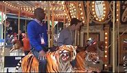 Salk & Holley ride a tiger carousel