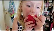 Ella tries to pull loose tooth by eating apple
