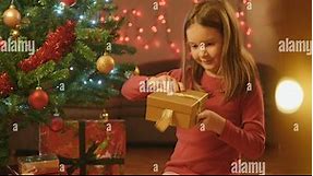 Family Christmas - Cute Little girl Opens her Christmas Present Stock Video Footage - Alamy
