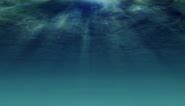 Free stock video - Underwater light filters down through blue water (loop) 1