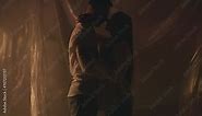 Slow motion silhouette two young lovers embracing and kissing each other. Blinking light when couple kisses indoors. Romance passionate foreplay after date. Romantic relationships