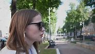 side view of a woman smoking a cigarette in the city on the street in summer