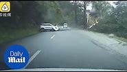 Shocking moment car is smashed by a massive BOULDER