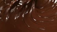 Premium stock video - Mixing melted liquid dark chocolate with a whisk