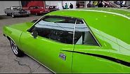 Restomod HEMI Cuda in lime green with a fantastic stance that is very well done in Mecum Indy
