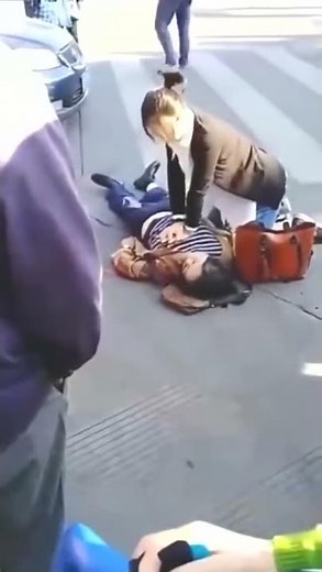 CPR on woman in the street