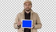 Man walking and holding tablet with blue screen mockup Alpha