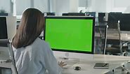 Woman typing on a blank computer screen in the office - Free Stock Video