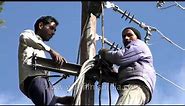 Hoisting heavy duty electrical cables onto pole for installation, in India