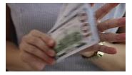 Download Business and financial concept, money in hand, dollar bill in hand, female hand holding money dollar for free