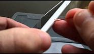 Open iPhone SIM tray with a paperclip