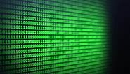 Blur binary code on computer screen background. Green digits listing table. Side view. Data technologic concept