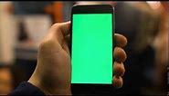 4k close up of hand holding a smartphone with green screen display at underground train station shot