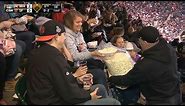 Fan shares big bag of popcorn in the stands