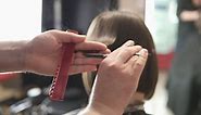 Free stock video - Closeup view of a hairdresser's hands cutting hair with scissors 1