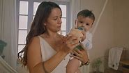 Young mom lifting her baby with her arms - Free Stock Video