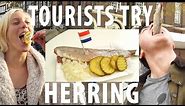 Tourists Try Dutch Herring