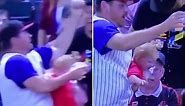 Wild moment fan almost drops his child but saves his beer catching baseball