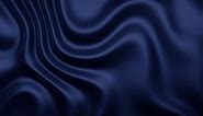 Abstract background of dark blue silky wave patterns, evoking a sense of fluidity and the graceful flow of fabric or water in the moonlight.