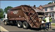 Republic's brown Mack MRU McNeilus rear loader garbage truck packing heavy trash and bulk