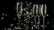 Free FHD Stock Animation of gold confetti falling over glasses of champagne on black background
