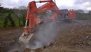 Hitachi 870 excavator loading dumpers on a road construction 2021
