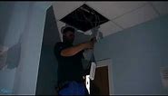 Installation of 600 x 600 LED panel light fitting with emergency capabilities