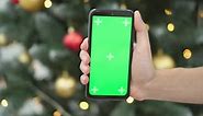 Hand Holding Smartphone with Green Screen on Chroma Key