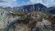 Flying a drone towards scenic mountain landscape in Albania, outdoor travel Europe