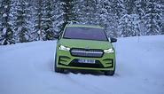The new Skoda Enyaq RS iV in Mamba Green Driving in the snow