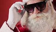 Cheerful Santa Claus Pulling Down Sunglasses and Winking