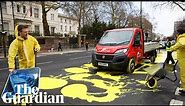 Protesters paint Ukrainian flag outside Russian embassy in London