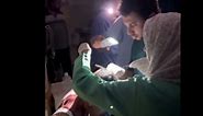 Gaza hospital staff stitch head wound under torchlight