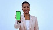 Portrait of black woman with phone, green screen in studio mobile app, website info