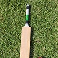 Cricket Bat and Ball On Grass