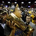 Steph Curry Holding Championship Trophy
